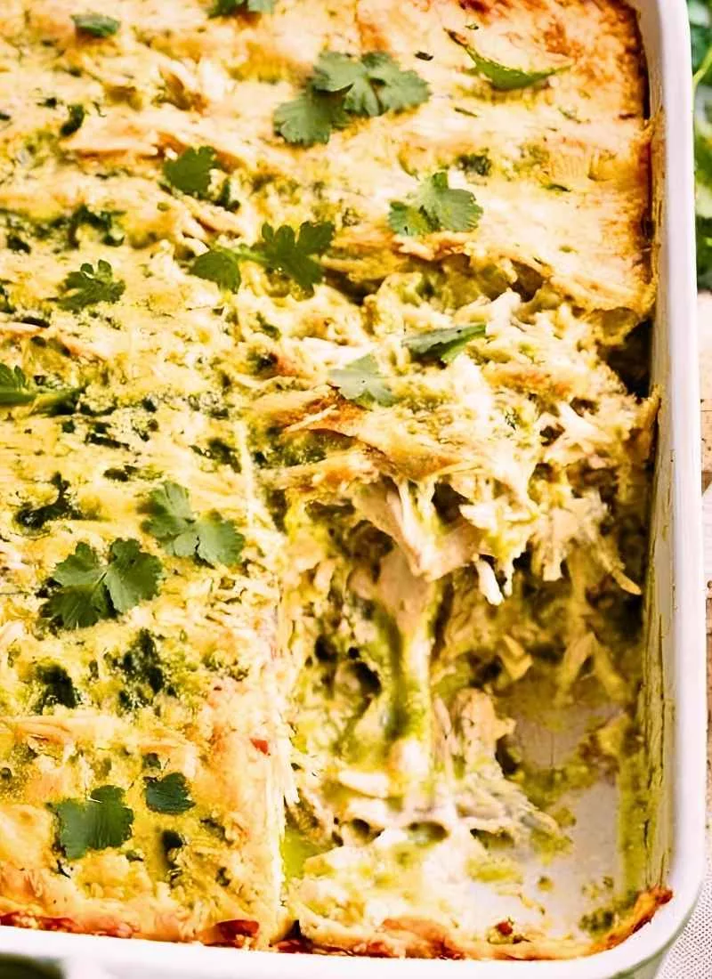 Salsa Verde Chicken Casserole – Close up of a cheesy golden brown casserole with tender shredded chicken and thick layers of salsa verde sauce No garnish