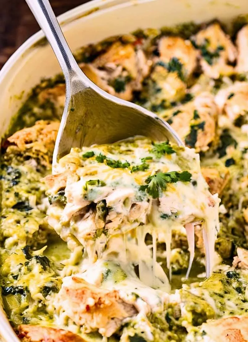Salsa Verde Chicken Casserole – Spoon digging into a bubbling hot casserole showing tender chicken creamy salsa verde and melted cheese No