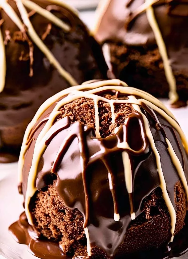 Triple Chocolate Cake Balls – Close up of rich triple chocolate cake balls with a thick slightly glossy chocolate coating Cracks on the shell expose layers of dark milk and white chocolate R ()
